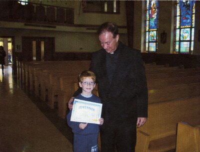 <i>Kyle, with our Pastor, Father Quinter.</i>